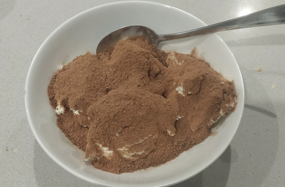 A lot of Milo sprinkled on top of vanilla ice cream. 