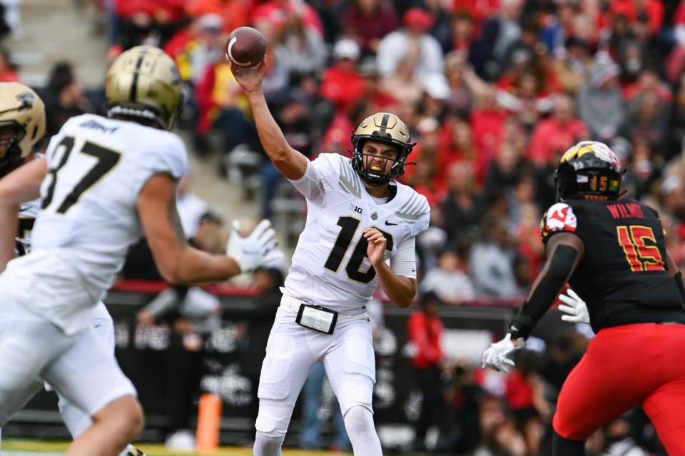 Oct 8, 2022; College Park, Maryland, USA;  Purdue Boilermakers quarterback Aidan O'Connell (16) throws to tight end Payne Durham (87) as Maryland Terrapins defensive lineman Riyad Wilmot (15) rushes during the first half  at SECU Stadium.