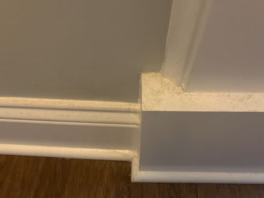 A Baseboard Buddy cleaning tool