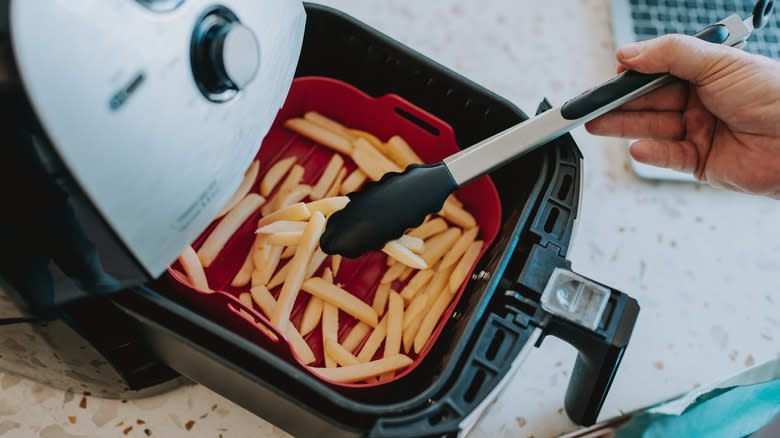 Tossing french fries in an air fryer