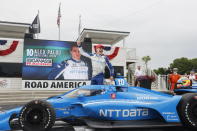 Alex Palou celebrates his victory in an IndyCar race at Road America in Elkhart Lake, Wisc., Sunday, June 20, 2021. (AP Photo/Jeffrey Phelps)