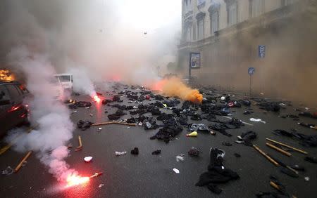 Clothes used by protesters are seen left on the ground during a rally against Expo 2015 in Milan, May 1, 2015. REUTERS/Stefano Rellandini