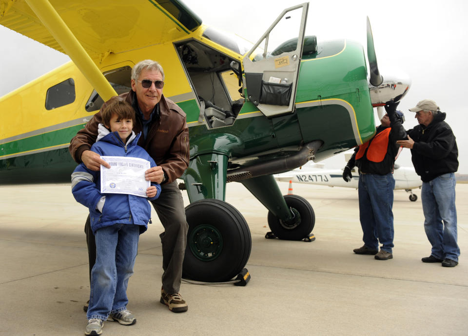 Actor Harrison Ford visits Denver and gives some kids an airplane ride from Centennial Airport. Sean Keeney, 8, of Littleton gets his photo taken with Ford after his plane ride. For Bill Husted column. Kathryn Scott Osler, The Denver Post  (Photo By Kathryn Scott Osler/The Denver Post via Getty Images)