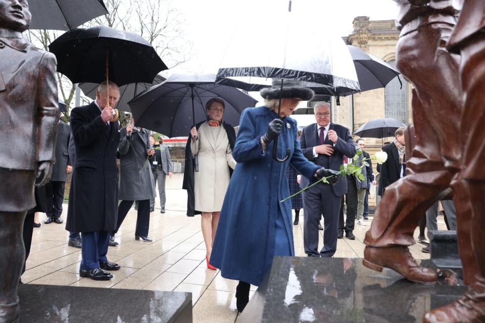 King Charles III and the Queen Consort lay a rose during a visit to the Kindertransport Memorial to mark the 85th anniversary of the first Kindertransport (PA)