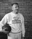 In this undated photo provided by the University of Nebraska-Lincoln, former Nebraska basketball coach Jerry Bush holds a basketball. Nebraska's current NCAA college basketball coach Fred Hoiberg is his grandson. Hoiberg said he wishes Bush could have seen him play college and pro basketball, and he would have loved to have talked about coaching with him. He keeps a scrapbook with newspaper clippings from the Bush era on a table in his office, and he said he feels a connection. (University of Nebraska Lincoln via AP)