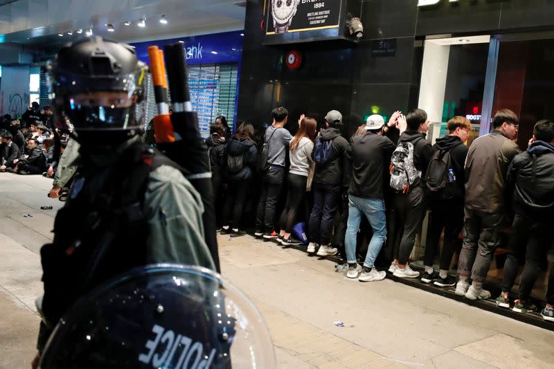 Riot police detain anti-government protesters in a large scale during a legal demonstration on the New Year's Day to call for better governance and democratic reforms in Hong Kong