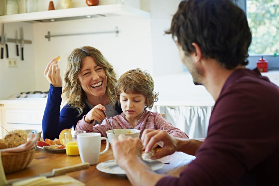 happy family enjoying breakfast at table