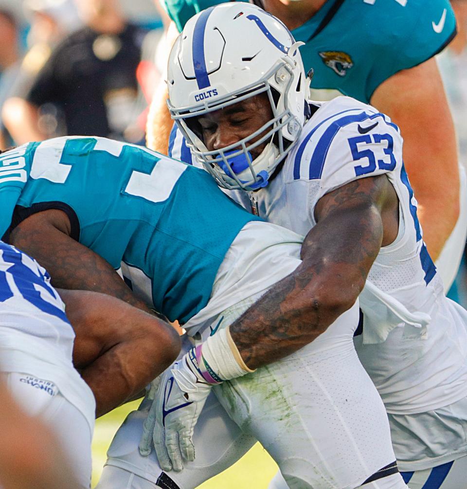 Indianapolis Colts outside linebacker Darius Leonard (53) tackles Jacksonville Jaguars running back Dare Ogunbowale (33) during the fourth quarter of the game on Sunday, Jan. 9, 2022, at TIAA Bank Field in Jacksonville, Fla. The Colts lost to the Jaguars, 11-26. 