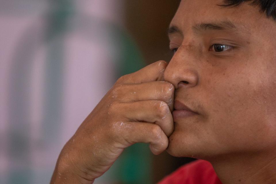 Kevin Hernandez, 22, is overcome with tears as he attempts to tell the story of extortion and threats that drove him and his partner, Marcela, to flee Honduras with their child.