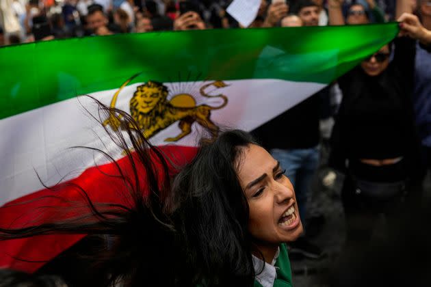 A woman shouts slogans next to an Iranian flag during a protest against the death of Iranian Mahsa Amini, outside Iran's general consulate in Istanbul, Wednesday, Sept. 21. (Photo: Francisco Seco/AP)