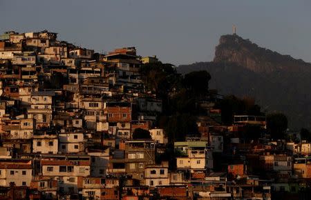 Christ the Redeemer is seen behind Morro da Coroa (Coroa slum) in Rio de Janeiro, Brazil, July 13, 2016. REUTERS/Ricardo Moraes