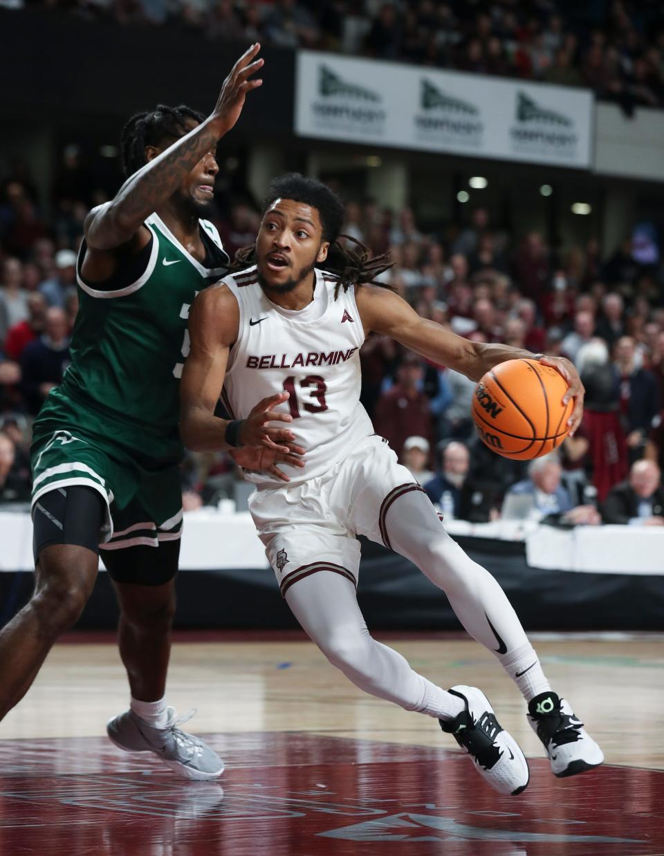 Bellarmine’s Dylan Penn (13) drives against Jacksonville’s Bryce Workman (5) during the ASUN Championship game in Louisville, Ky. on Mar. 8, 2022.  Bellarmine won 77-72.