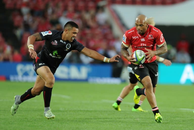 The Lions' Lionel Mapoe (R) fights for the ball with the Queensland Reds' Duncan Paia'aua during their Super Rugby match, at Ellis Park in Johannesburg, on March 18, 2017