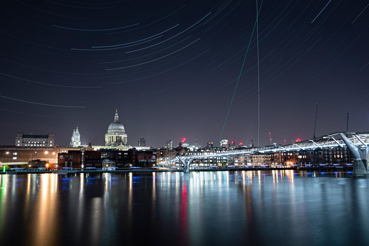 LONDON, ENGLAND - APRIL 22: (Multiple exposures were combined in camera to produce this image.) The London Millennium Footbridge is illuminated under the stars on a clear night on April 22, 2020 in London, England. The clear skies created by the New Moon coincide with the Lyrid meteor shower, an annual display caused by the Earth passing through a cloud of debris from a comet called C/186 Thatcher.  (Photo by Simon Robling/Getty Images)