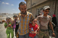 <p>Iraqis flee from the Old City of Mosul on June 22, 2017, during the ongoing offensive by Iraqi forces to retake the last district still held by the Islamic State (IS) group. (Photo: Ahmad al-Rubaye/AFP/Getty Images) </p>