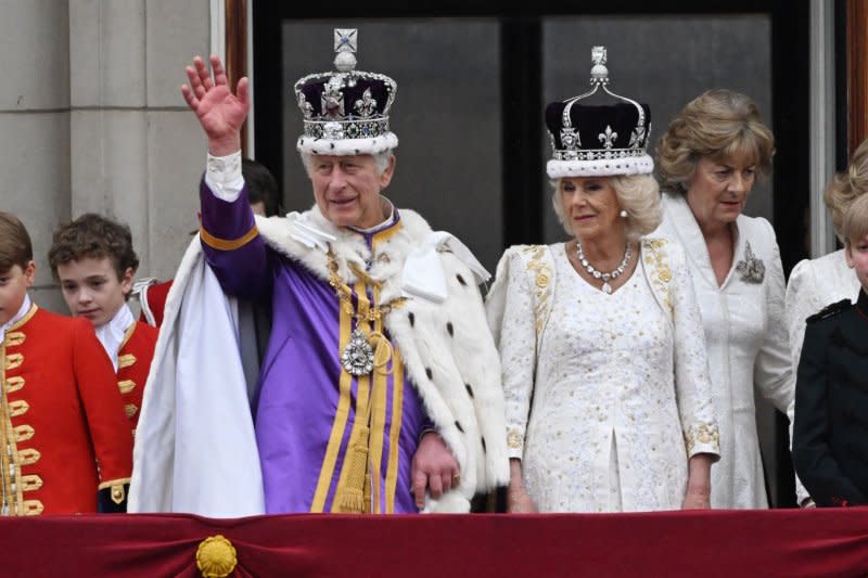 King Charles III and Queen Camilla wave to the public below from the balcony of Buckingham Palace after King Charles's coronation at Westminster Abbey in London in May 2023. File photo by Hugo Philpott/UPI