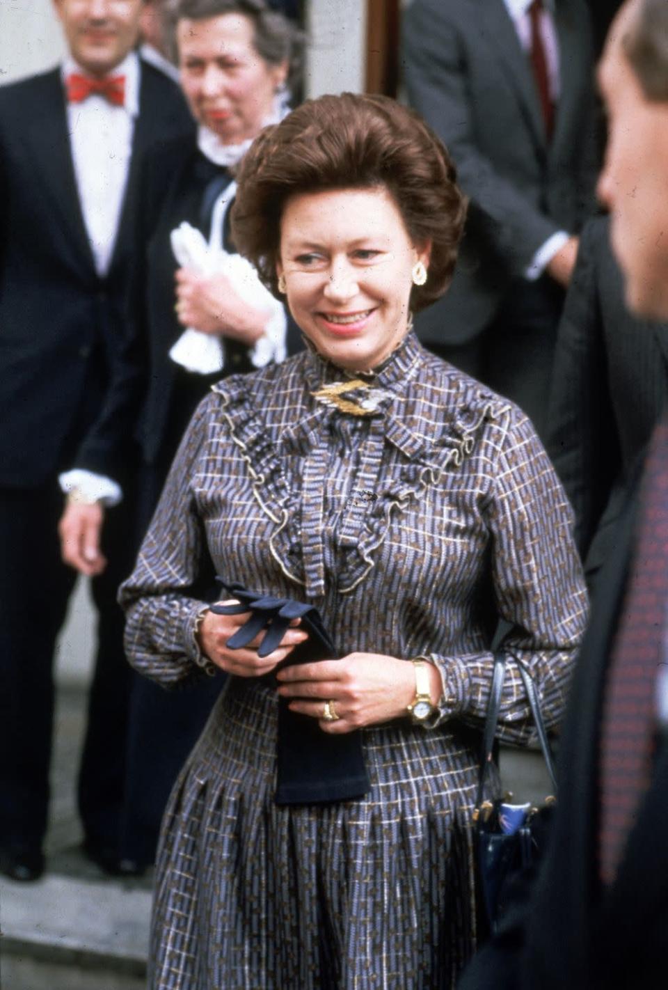 <p>Princess Margaret wears a patterned and pleated dress on a visit to the Institute of Directors in Pall Mall, London, on April 22, 1982. </p>