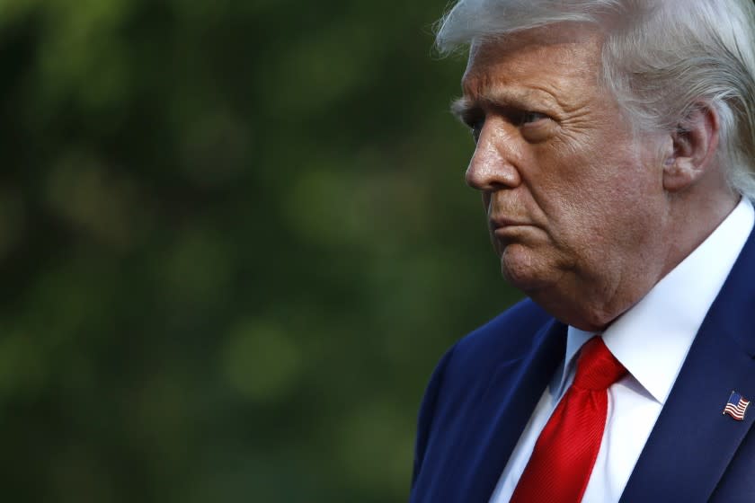 FILE - In this July 15, 2020, file photo President Donald Trump walks on the South Lawn of the White House in Washington after stepping off Marine One. Trump's pledge to rollback an Obama-era effort to eliminate racial disparities in America's suburbs is drawing harsh criticism from fair housing advocates, who call it a blatant attempt at racial politics and an appeal to white votes before the November election. (AP Photo/Patrick Semansky, File)