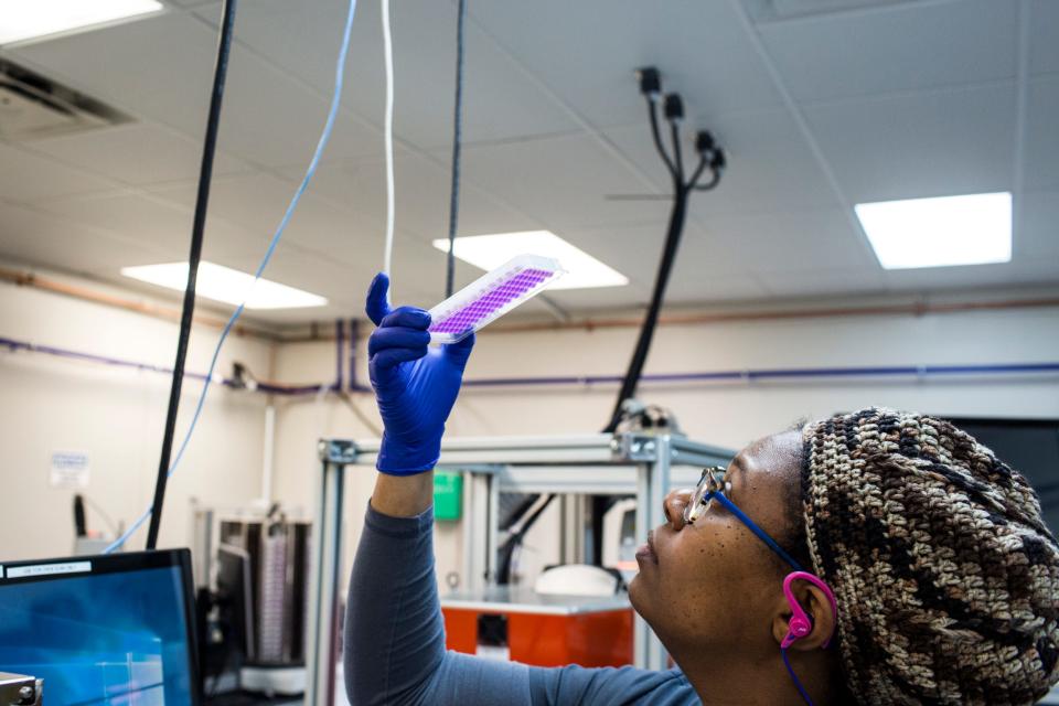 Lab technician DeNisha Washington works with samples at Transnetyx in Cordova on Jan. 22, 2019. Among the perks offered by the biotechnology company is a massage therapist who visits every other week.