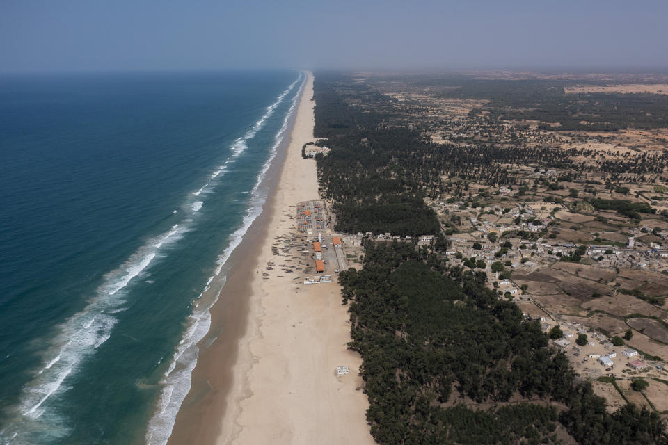 Filao trees, planted to slow coastal erosion along the Atlantic Ocean, line the beach in Lompoul village near Kebemer, Senegal, on Friday, Nov. 5, 2021. The trees form a curtain that protects the beginning of the Great Green Wall, a project that began in 2007 with a vision for the trees to extend like a belt across the vast Sahel region, from Senegal in the west to Djibouti in the east, by 2030. But as temperatures rose and rainfall diminished, millions of the planted trees died. (AP Photo/Leo Correa)