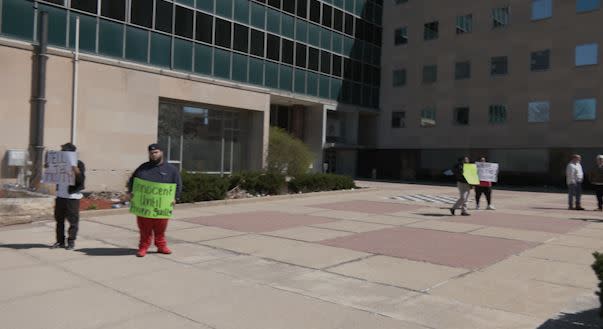 People gather outside Lansing City Hall April 13, demanding LPD release video footage from an April 10 shooting. (WLNS)