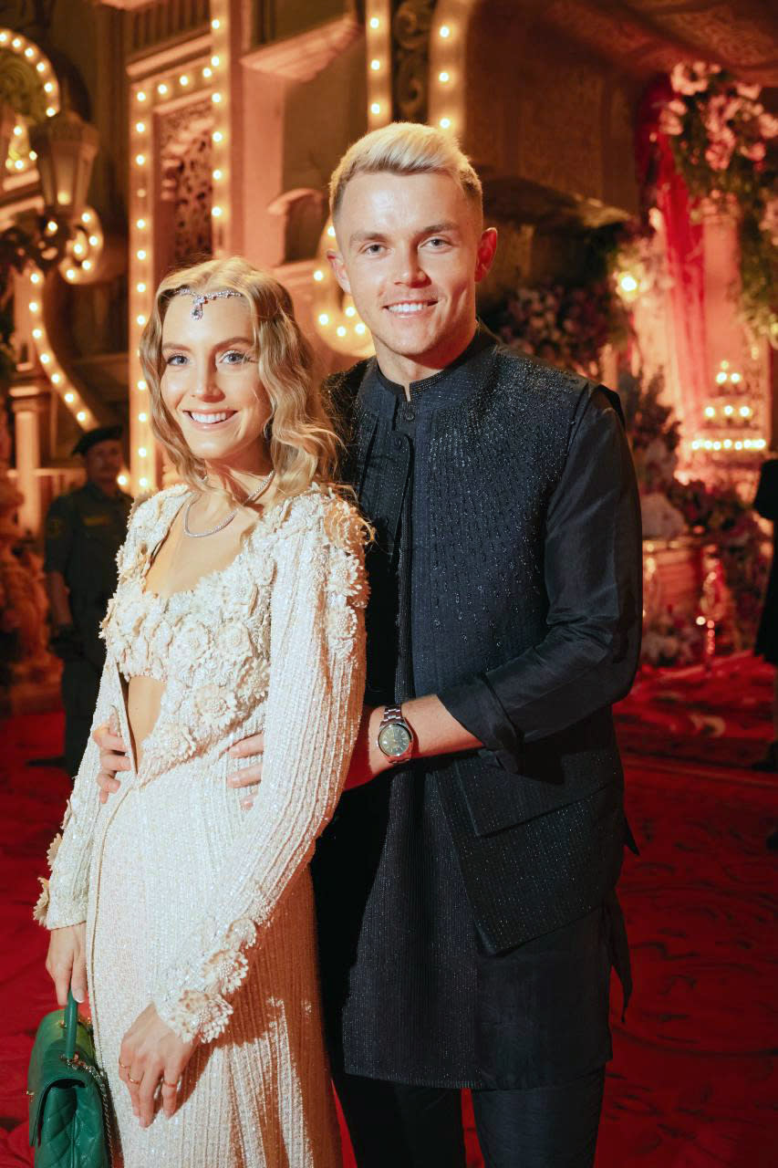 This photograph released by the Reliance group shows England's cricketer Sam Curran and Isabella Grace posing for a photograph at a pre-wedding bash of billionaire industrialist Mukesh Ambani's son Anant Ambani in Jamnagar, India, Saturday, Mar. 02, 2024. (Reliance group via AP)