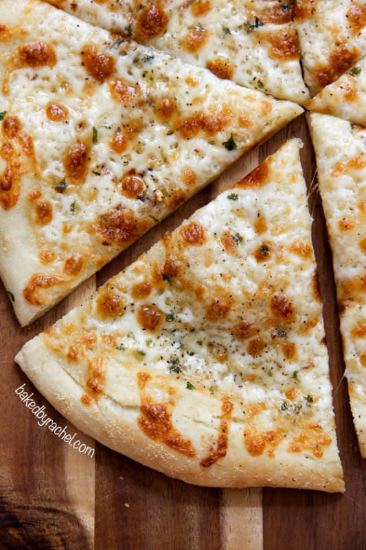 <p>Baked by Rachel</p><p>An easy homemade white garlic pizza featuring two kinds of cheese and a spicy kick!</p><p><strong>Get the recipe: <a href="https://www.bakedbyrachel.com/thin-crust-two-cheese-white-pizza/" rel="nofollow noopener" target="_blank" data-ylk="slk:Thin Crust Two-Cheese White Pizza;elm:context_link;itc:0;sec:content-canvas" class="link rapid-noclick-resp">Thin Crust Two-Cheese White Pizza</a></strong></p><p><strong>Related: <a href="https://parade.com/1274202/alison-ashton/celebrity-pizza-recipes/" rel="nofollow noopener" target="_blank" data-ylk="slk:How to Make the Best Pizza Dough at Home;elm:context_link;itc:0;sec:content-canvas" class="link rapid-noclick-resp">How to Make the Best Pizza Dough at Home</a></strong></p>