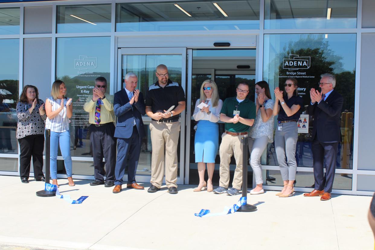 Medical director Dane Black cuts the ribbon to celebrate Adena's new urgent care center on Bridge Street.