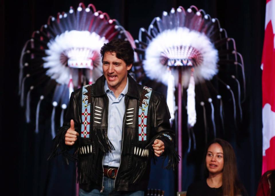 Prime Minister Justin Trudeau gestures after receiving a leather jacket at a ceremony while visiting the Tsuu T'ina First Nation near Calgary, Alta., Friday, March 4, 2016. THE CANADIAN PRESS/Jeff McIntosh