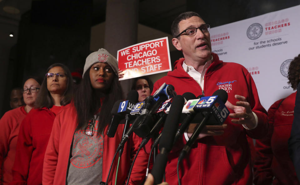 Chicago Teachers Union President Jesse Sharkey, right, and Vice President Stacy Davis Gates, third from left, speak following a CTU House of Delegates meeting at the Chicago Teachers Union Center on Tuesday, Oct. 29, 2019, in Chicago. (Chris Sweda/Chicago Tribune via AP)