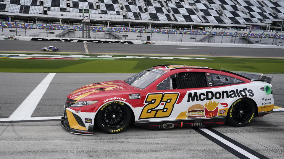 Bubba Wallace (23) heads down pit road before going out on the track to run laps during NASCAR auto race practice at Daytona International Speedway, Tuesday, Feb. 15, 2022, in Daytona Beach, Fla. (AP Photo/John Raoux)