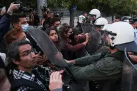 <p>Demonstrators scuffle with riot police, during a protest following the death of Mahsa Amini, outside the Iranian Embassy, in Athens, Greece, September 22, 2022. REUTERS/Costas Baltas</p> 