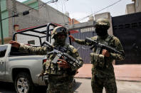 Mexican marine soldiers stand guard outside a house after suspected gang members were killed on Thursday in a gun battle with Mexican marines in Mexico City, Mexico, July 21, 2017. REUTERS/Henry Romero
