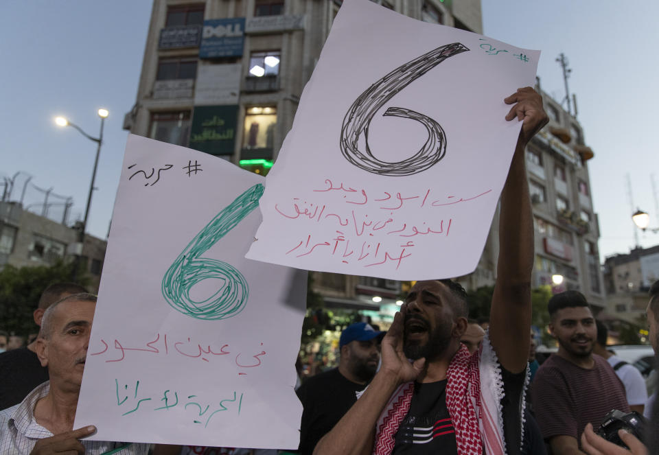 Protesters chant anti Israel slogans and carry placards that read "six lions found the light at the end of the tunnel, freedom for our prisoners," during a rally supporting Palestinian prisoners in Israeli jails, in the West Bank city of Ramallah, Wednesday, Sept. 8, 2021. Pressure built around Israel's prison system Wednesday after fires broke out at several facilities and the government searched for six Palestinian escapees who have been on the run since they tunneled out two days earlier. (AP Photo/Nasser Nasser)