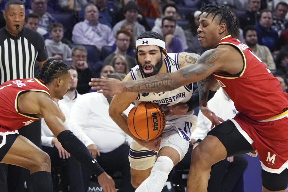 Northwestern guard Boo Buie, center, drives as Maryland guard Jahmir Young, left, and guard DeShawn Harris-Smith defend during the second half of an NCAA college basketball game in Evanston, Ill., Wednesday, Jan. 17, 2024. (AP Photo/Nam Y. Huh)