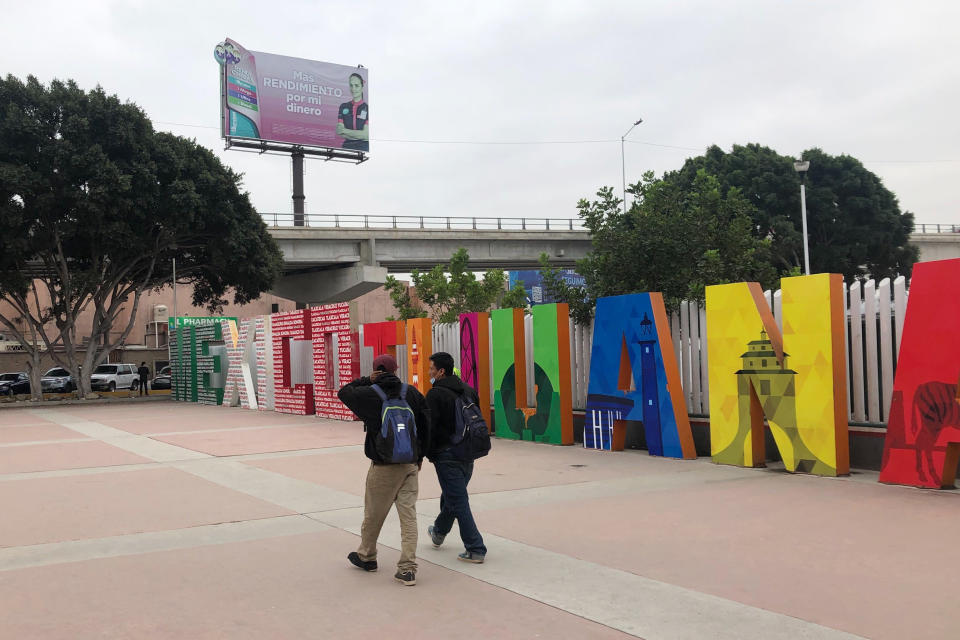 Victor Díaz and Juan Pascual leave a plaza where Mexicans are returned in Tijuana from the U.S., on Oct. 9, 2020. The suspension of asylum and the introduction of “express deportations,” as migrants call them, have accelerated a shift in who's crossing the border illegally: more Mexican men who come for economic reasons and far fewer from Central America, Africa and elsewhere who seek asylum. (AP Photo/Elliot Spagat)