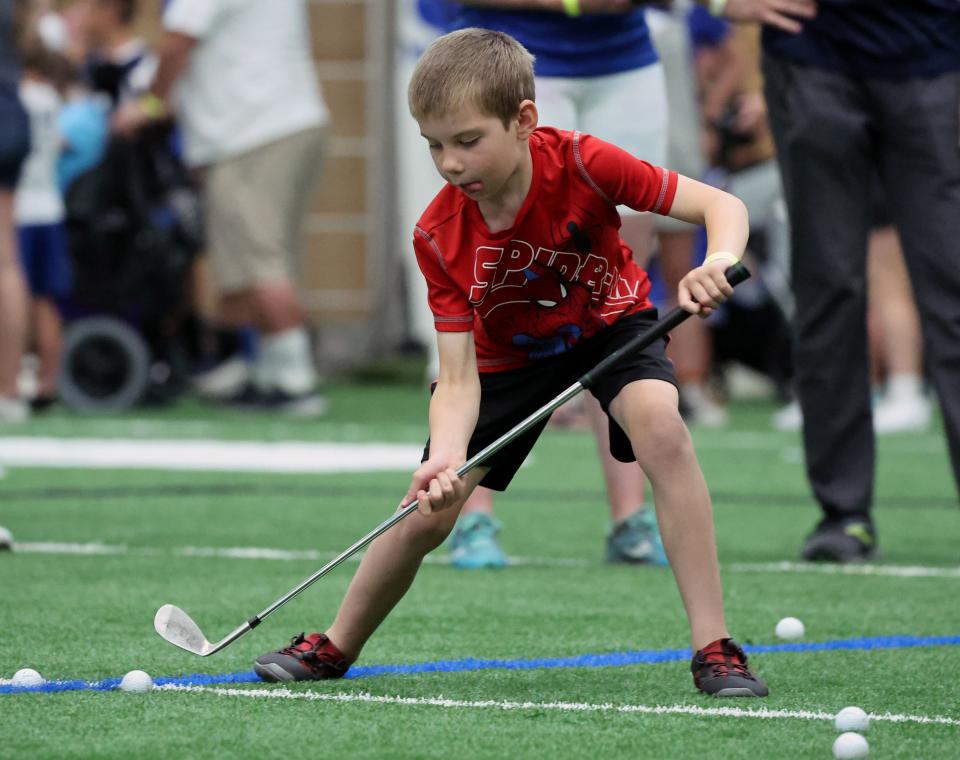 Marcus Nelson tries his hand at golf inside the Indoor Practice Facility as BYU holds a party to celebrate their move into the Big 12 Conference with music, games and sports exhibits in Provo on Saturday, July 1, 2023. | Scott G Winterton, Deseret News