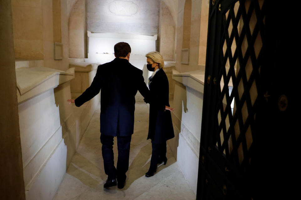 France's President Emmanuel Macron and European Commission President Ursula von der Leyen pay their respects in the Crypt during a ceremony to pay tribute to late French politician Simone Veil and diplomat Jean Monnet, at the French Pantheon in Paris, Friday, Jan. 7, 2022. French president Emmanuel Macron paid a tribute to a pair of leading European figures Friday as France formally took the reins of the 27-nation bloc for the next six months with big ambitions. (Ludovic Marin, Pool Photo via AP)