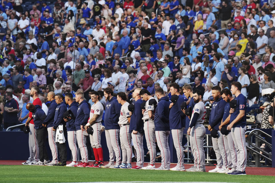 Boston Red Sox players stand to observe a moment of silence for Willie Mays before the team's baseball game against the Toronto Blue Jays on Wednesday, June 19, 2024, in Toronto. (Nathan Denette/The Canadian Press via AP)