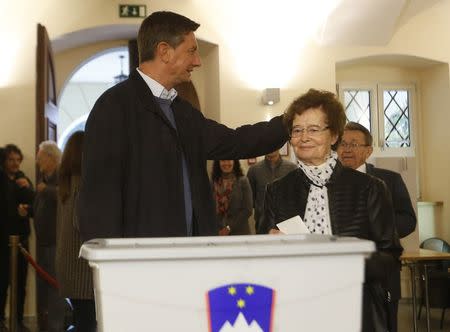 Presidential candidate Borut Pahor and his mother Ivica Martelanc cast their votes at a polling station during the presidential election in Sempeter pri Novi Gorici, Slovenia October 22, 2017. REUTERS/Srdjan Zivulovic