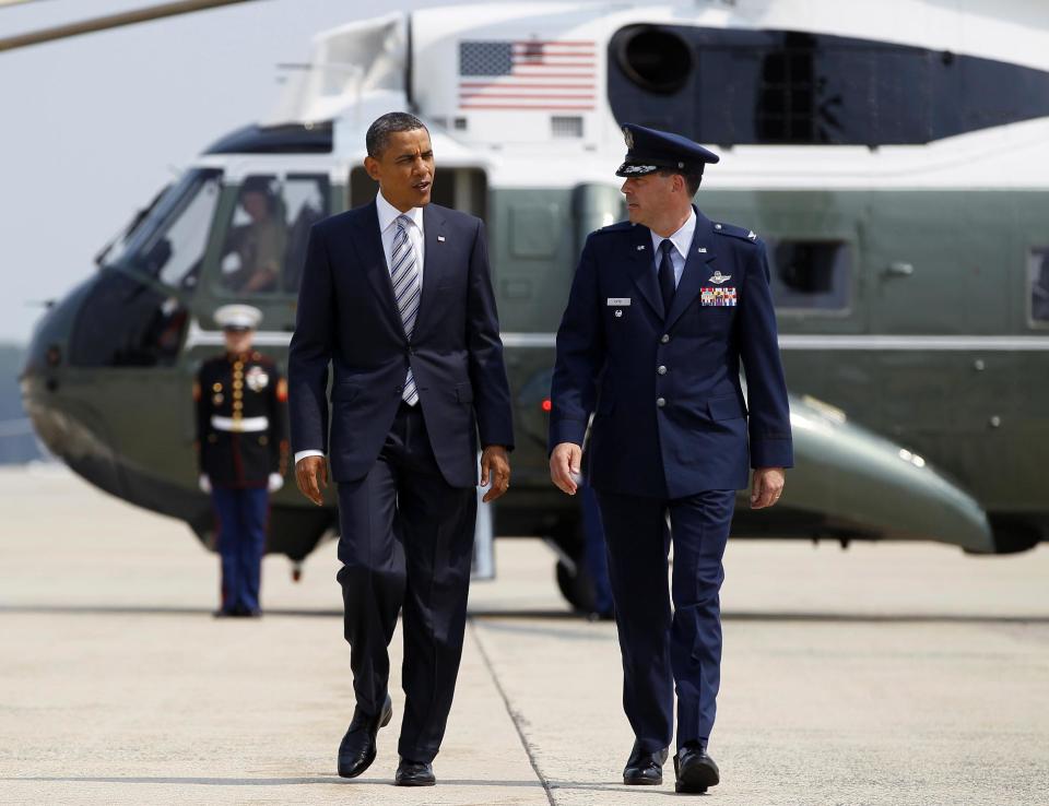 President Barack Obama walks from Marine One with Col. Greg N. Urtso to board Air Force One, Friday, June 29, 2012, at Andrews Air Force Base, Md., enroute to Colorado. (AP Photo/Carolyn Kaster)