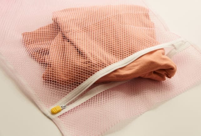 Some more delicate clothes are safe to machine wash if you put them in a laundry bag before you pop them in your washer. Turn them inside out before you do.