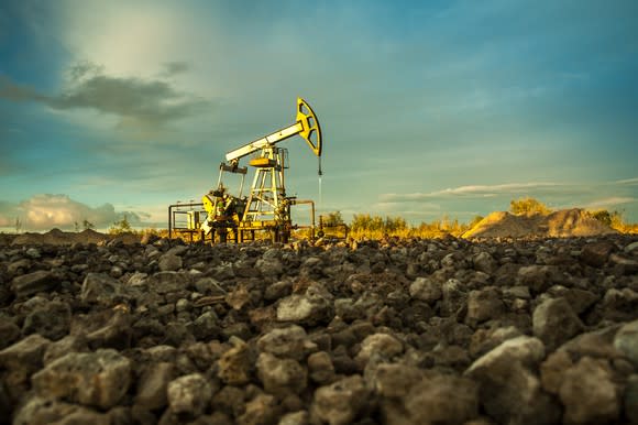 An oil pump with rocks in the foreground.