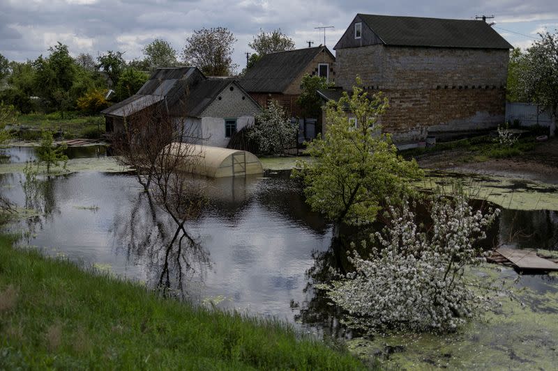 FILE PHOTO: A house is seen flooded at an area after Ukrainian military forces opened a dam to flood an residencial area in order to stop advance of Russian forces to arrive to the capital city of Kyiv, in Demydiv, Ukraine