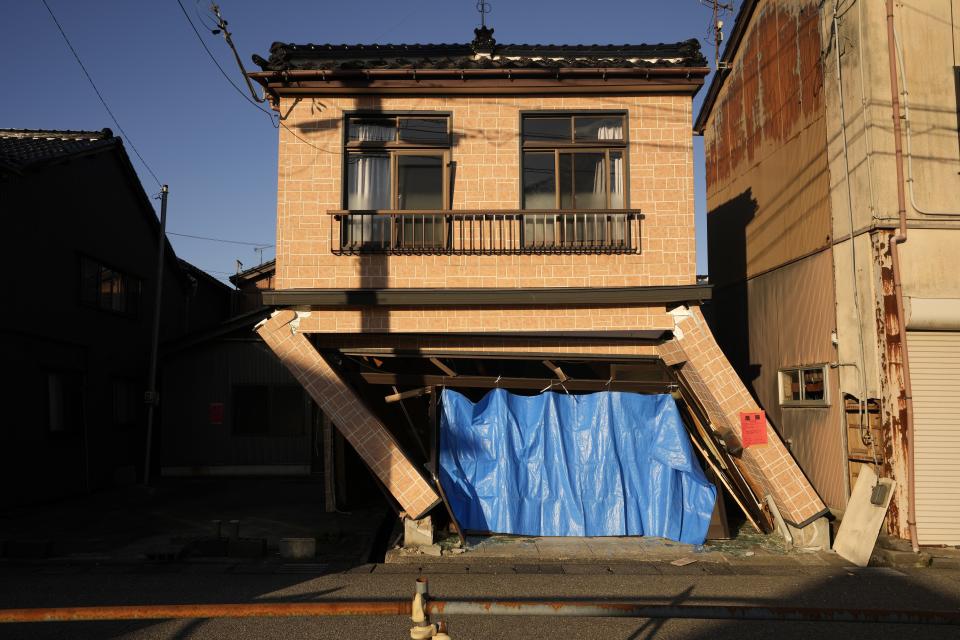 A collapsed house damaged by powerful earthquake are seen in Anamizu in the Noto peninsula facing the Sea of Japan, northwest of Tokyo, Thursday, Jan. 4, 2024. More soldiers have been ordered to bolster the rescue operations Thursday, providing those in need with drinking water, hot meals and setting up bathing facilities after a magnitude 7.6 quake hit Ishikawa Prefecture and nearby regions Monday. (AP Photo/Hiro Komae)