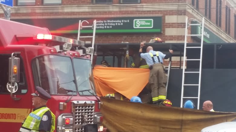 Firefighters and paramedics free injured worker from hot tar truck in Toronto