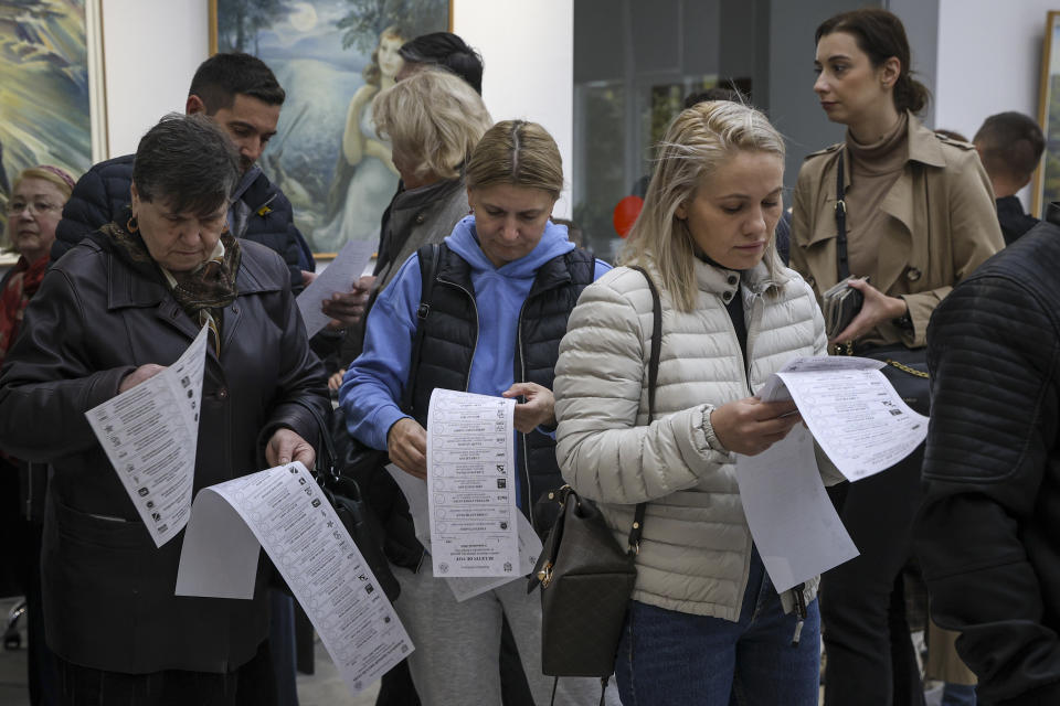 FILE - Moldovans look at candidates lists on the ballot during local elections in Chisinau, Moldova on Nov. 5, 2023. Since Russia fully invaded Ukraine two years ago, a string of incidents in neighboring Moldova's Russia-backed breakaway region of Transnistria have periodically raised the specter that European Union candidate Moldova could also be in Moscow's crosshairs. (AP Photo/Aurel Obreja)