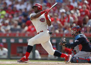 FILE - In this July 6, 2019, file photo, Cincinnati Reds' Yasiel Puig, left, follows through on a two-run home run off Cleveland Indians starting pitcher Shane Bieber during the first inning of a baseball game, in Cincinnati. The Indians bulked up for the playoff race by trading temperamental starter Trevor Bauer before the deadline to Cincinnati in a three-team deal they hope can help them run down the Minnesota Twins. Cleveland, which trails the AL Central by three games but leads the wild-card race, sent Bauer to the Reds for slugger Yasiel Puig and left-hander Scott Moss. The Indians also acquired outfielder Franmil Reyes, lefty Logan Allen and infield prospect Victor Nova from the San Diego Padres, who acquired outfielder Taylor Trammel from the Reds.(AP Photo/Gary Landers, File)