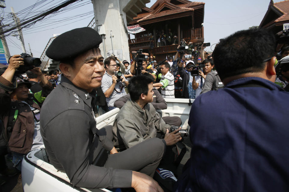 In this photo taken Monday, Jan. 27, 2014, high level police officers leave a protest site after pleading with a monk protest leader to leave the neighboring government building to Bangkok, Thailand. Some government officials have resorted to pleading with protests occupying their government offices where daily functions such as passport controls and immigration issues are backing up. It was an extraordinarily humbling moment for Prime Minister Yingluck Shinawatra's embattled administration, which ascended to power following a landslide election two and a half years ago. (AP Photo/Wally Santana)