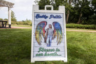 People donate money and distribute candles that will be later be lit in unison in support of the Petito family in Blue Point Nature Preserve Park in Blue Point, N.Y., on Thursday, Sept. 23, 2021. Search teams were back out at a Florida nature park to look for the boyfriend of Gabby Petito, the young woman who authorities say was killed while on a cross-country trip with him. (AP Photo/Brittainy Newman)